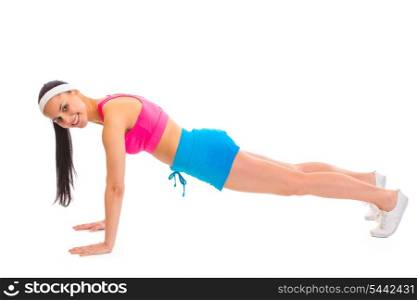 Smiling young sportsgirl doing push-up isolated on white&#xA;