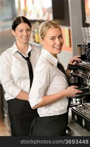 Smiling young waitresses serving coffee in restaurant