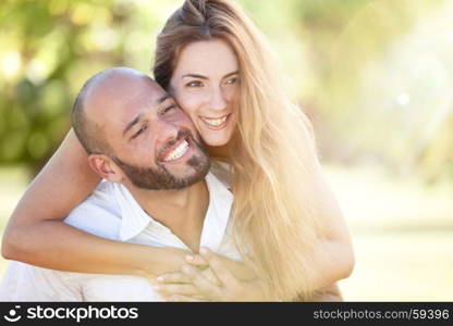 Smiling Young Woman and Young Man are Happy Together - they are Smiling and Embracing in Nature at the Bright Sunny Day