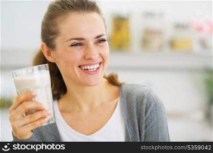 Smiling young woman drinking fresh cocktail