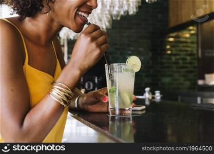 smiling young woman drinking mojito bar counter restaurant. High resolution photo. smiling young woman drinking mojito bar counter restaurant. High quality photo