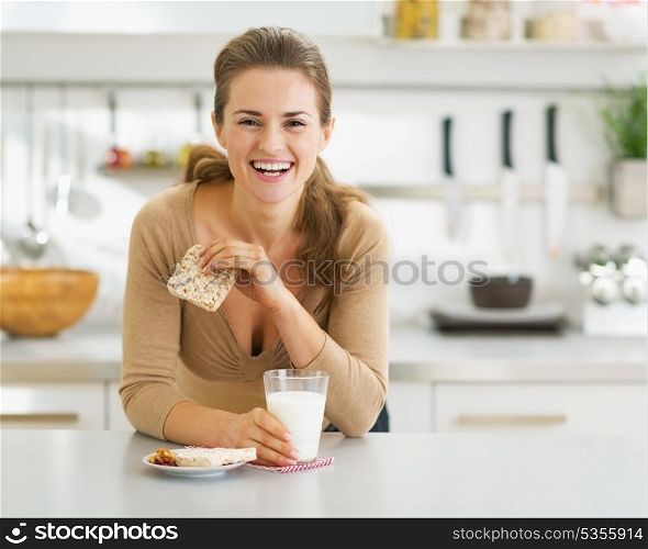 Smiling young woman having healthy breakfast