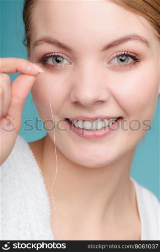 Smiling young woman hold dental floss.. Oral hygiene and health care. Smiling woman hold dental floss white healthy teeth.
