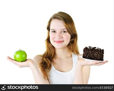 Smiling young woman holding apple and chocolate cake