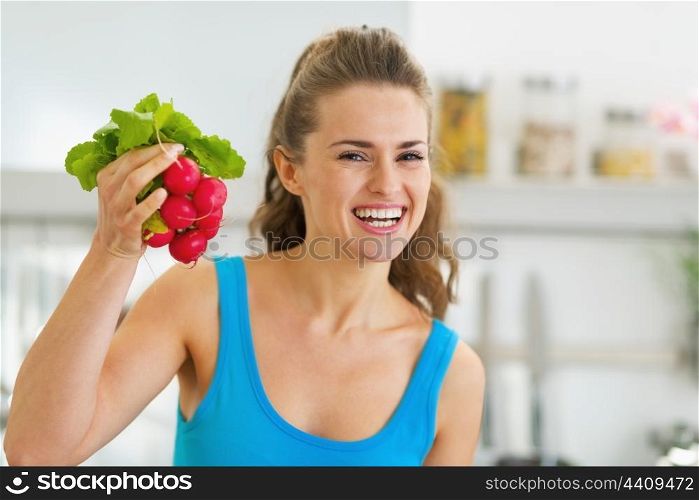 Smiling young woman holding bunch of radishes