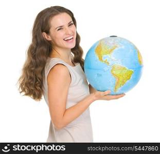 Smiling young woman holding globe