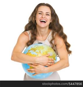 Smiling young woman hugging earth globe