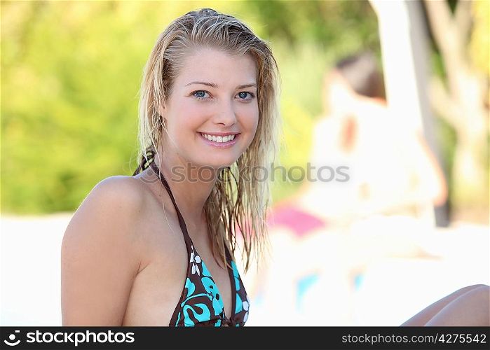Smiling young woman in a bikini