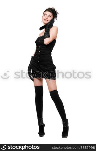 Smiling young woman in a black dress talking on the phone
