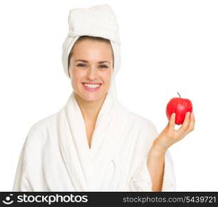Smiling young woman in bathrobe with apple