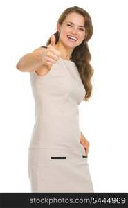 Smiling young woman in dress showing thumbs up