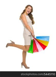 Smiling young woman in dress with shopping bags