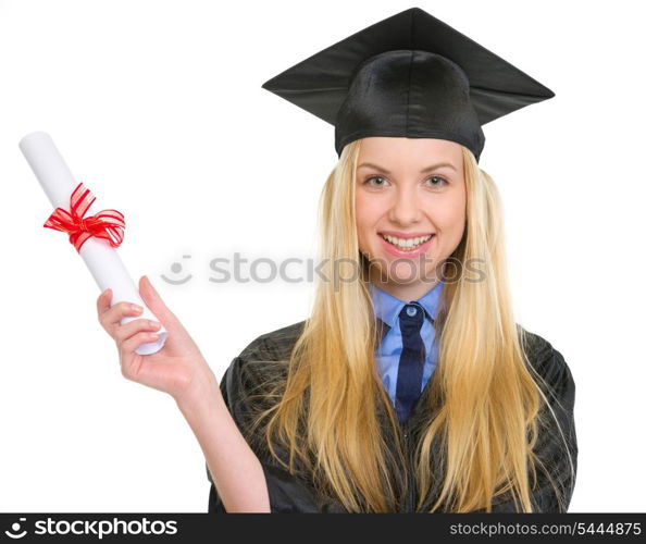 Smiling young woman in graduation gown holding diploma