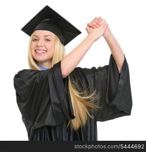 Smiling young woman in graduation gown rejoicing success