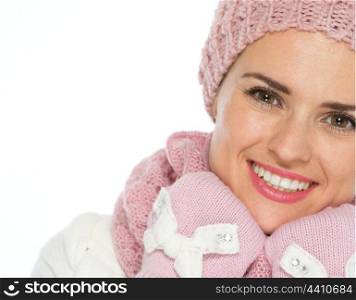 Smiling young woman in knit scarf, hat and mittens