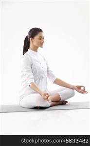 Smiling young woman in lotus position
