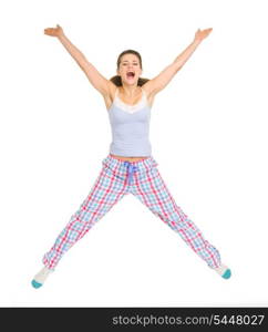 Smiling young woman in pajamas jumping