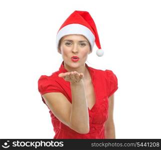 Smiling young woman in Santa hat blowing air kiss