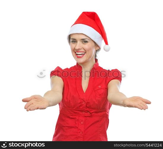 Smiling young woman in Santa hat showing something on empty palms