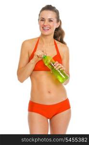 Smiling young woman in swimsuit holding bottle of water