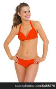 Smiling young woman in swimsuit looking on copy space