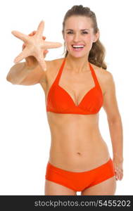 Smiling young woman in swimsuit showing starfish