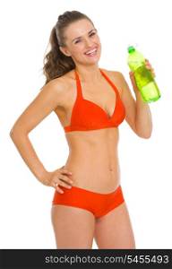 Smiling young woman in swimsuit with bottle of water