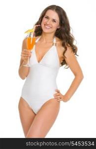 Smiling young woman in swimsuit with cocktail