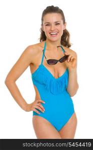 Smiling young woman in swimsuit with sunglasses