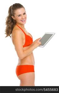 Smiling young woman in swimsuit with tablet pc
