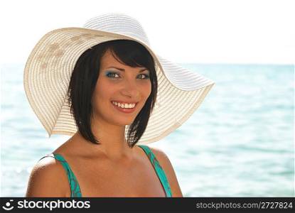 Smiling young woman in the white hat