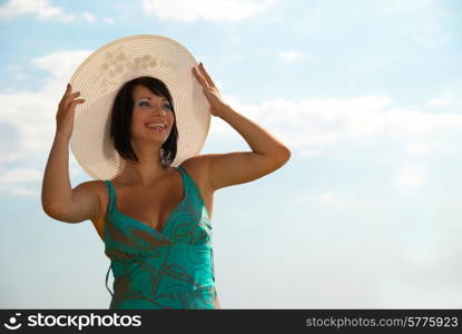 Smiling young woman in the white hat