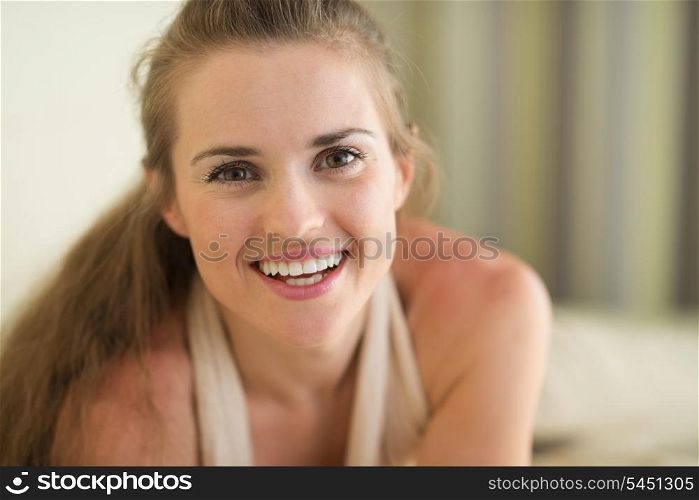 Smiling young woman laying on couch
