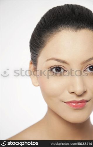 Smiling young woman looking away on white background