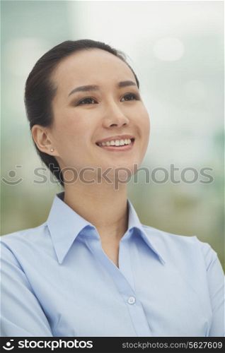Smiling young woman looking up