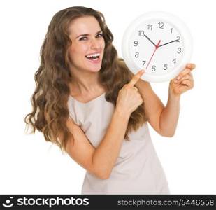 Smiling young woman pointing on clock
