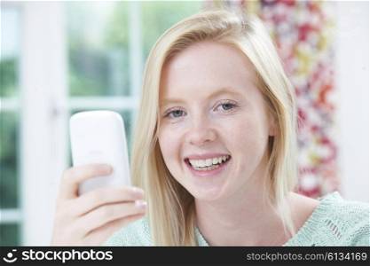 Smiling Young Woman Reading Text Message