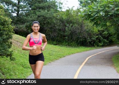 Smiling young woman running for fitness