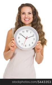 Smiling young woman showing clock