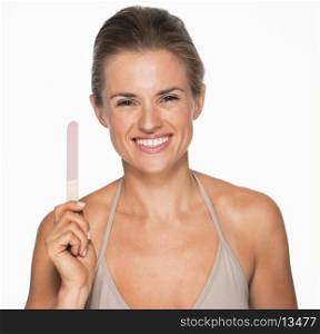 Smiling young woman showing nail file