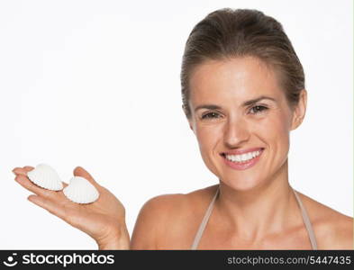 Smiling young woman showing seashells