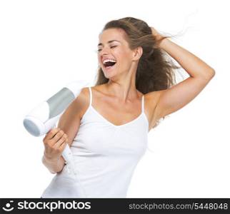 Smiling young woman singing while blow-dry