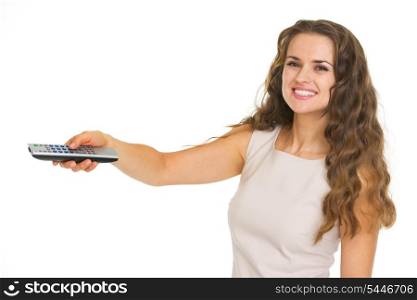 Smiling young woman switching channels with tv remote control