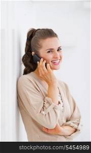 Smiling young woman talking cell phone