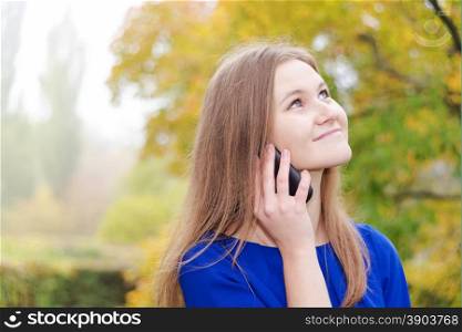 Smiling young woman talking on the phone
