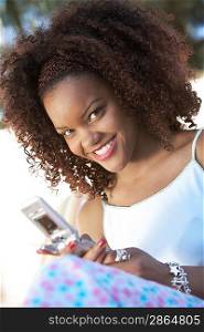 Smiling Young Woman Using Cell Phone