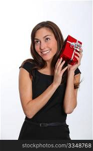 Smiling young woman with christmas gift