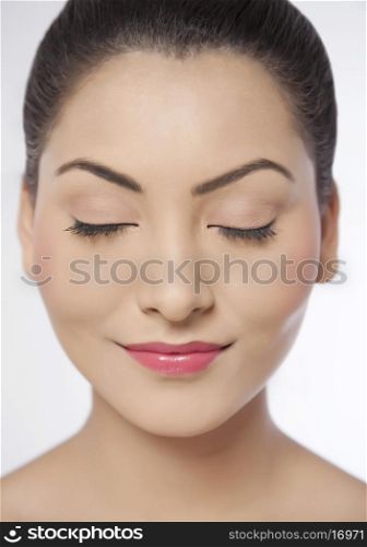 Smiling young woman with eyes closed