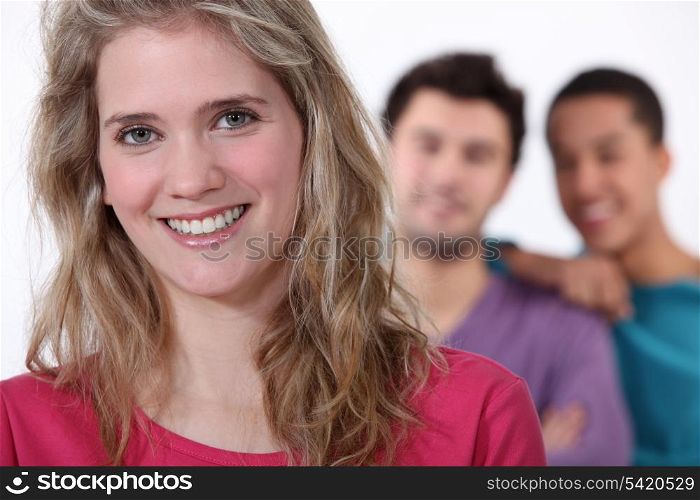 Smiling young woman with lads in the background