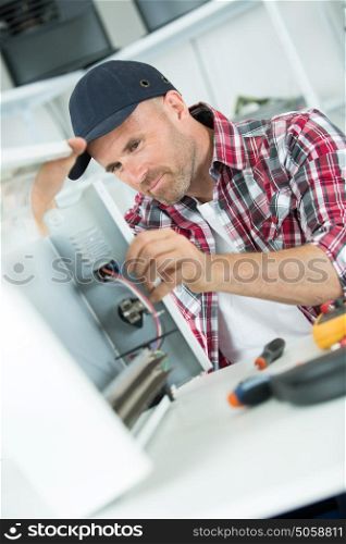 smily repairman fixing computer unit